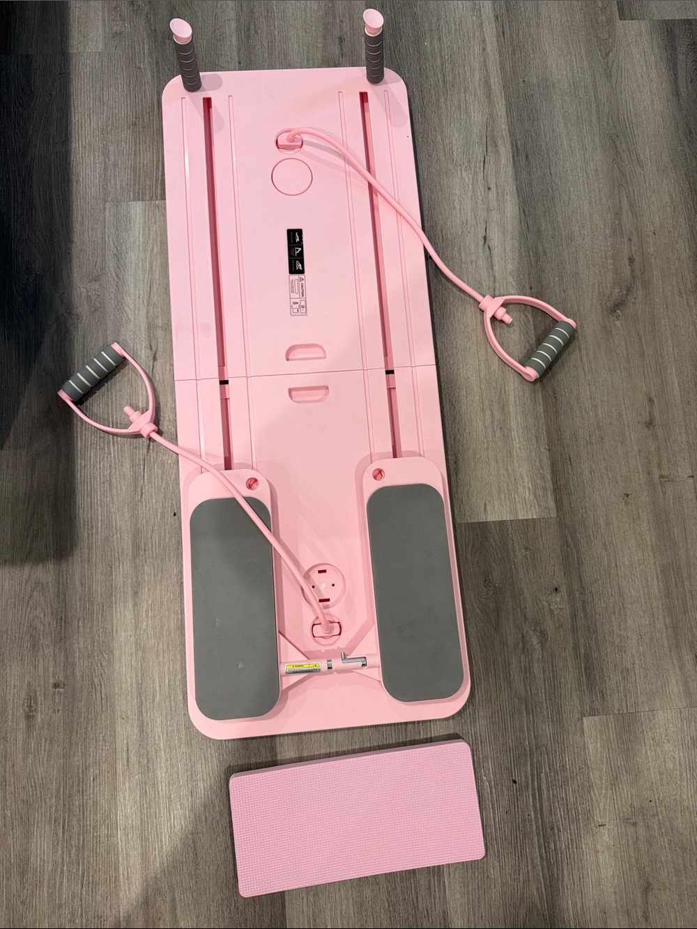 Pink Pilates Reformer with detachable resistance bands. Foldable